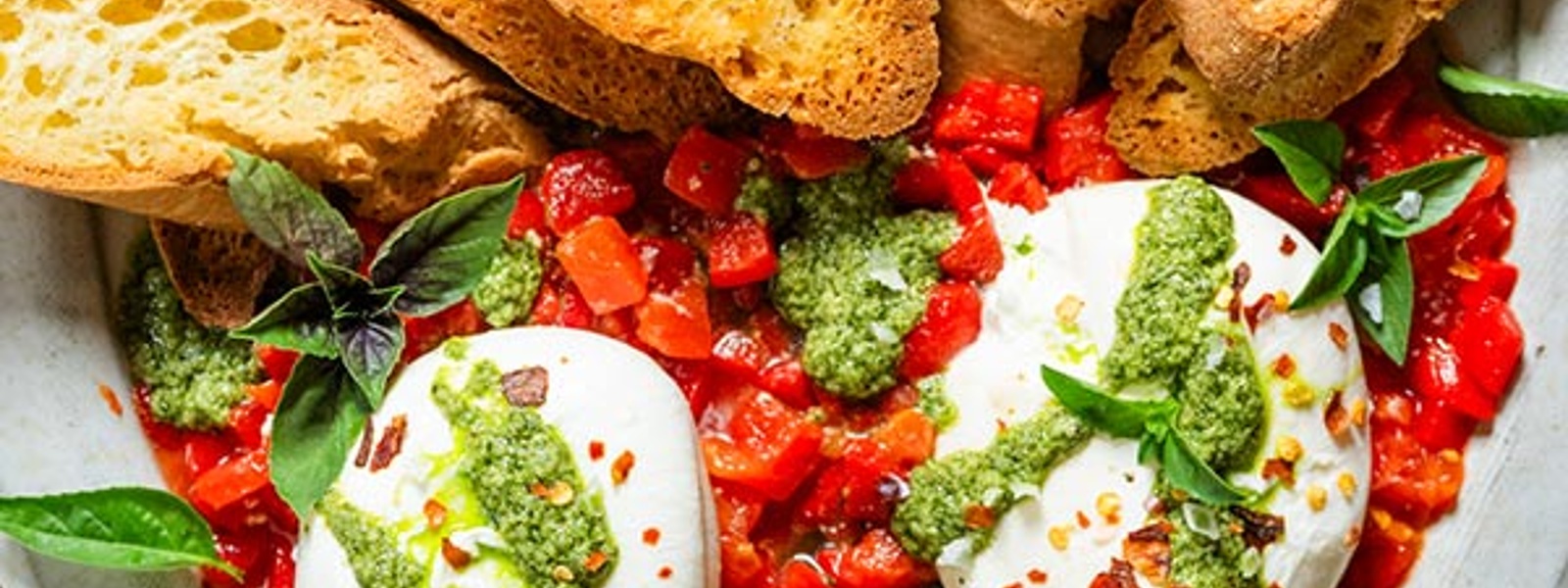 Burrata with walnut pesto and roasted peppers with crostini