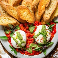 Burrata with walnut pesto and roasted peppers with crostini