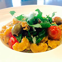 Whole grain pasta with olives, tomatoes and arugula