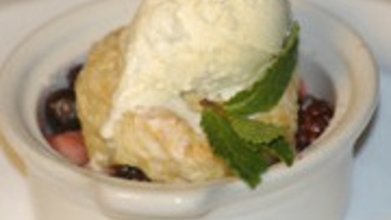 Wild berry cobbler with sweet butter milk biscuit and vanilla ice cream