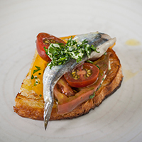 Anchovy and heirloom tomato crostini