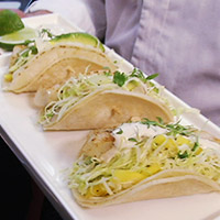 Fish tacos with avocado and mango slaw