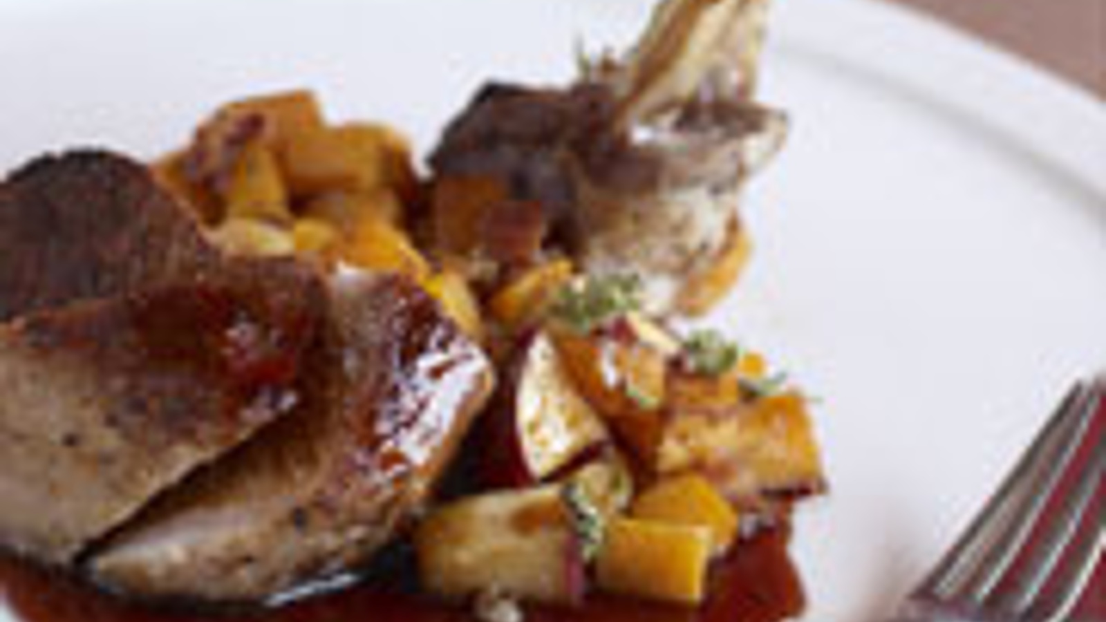 Grilled pork chop with pomegranate molasses and butternut squash "hash"