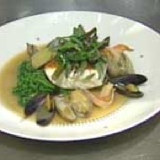 Pan-roasted halibut with cioppino broth, shellfish and seasonal vegetables