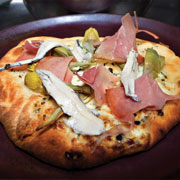 Baby artichoke flatbread with anchovies and prosciutto