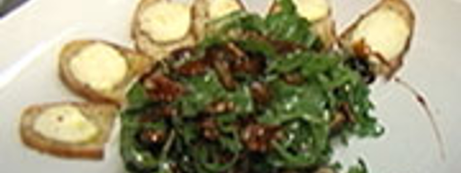 Arugula salad with dates, pecans and goat cheese toasts