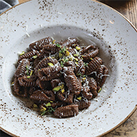 Semolina and cocoa gnocchi with pecorino and pistachios