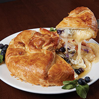 Brie en croute with blueberries and pistachios