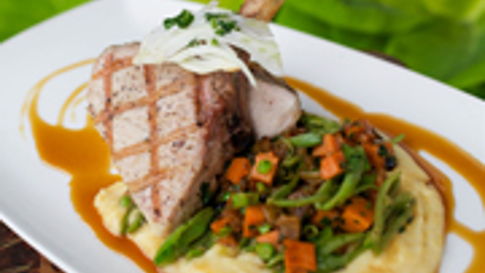 Pork chop with succotash, polenta and caramelized fennel sauce